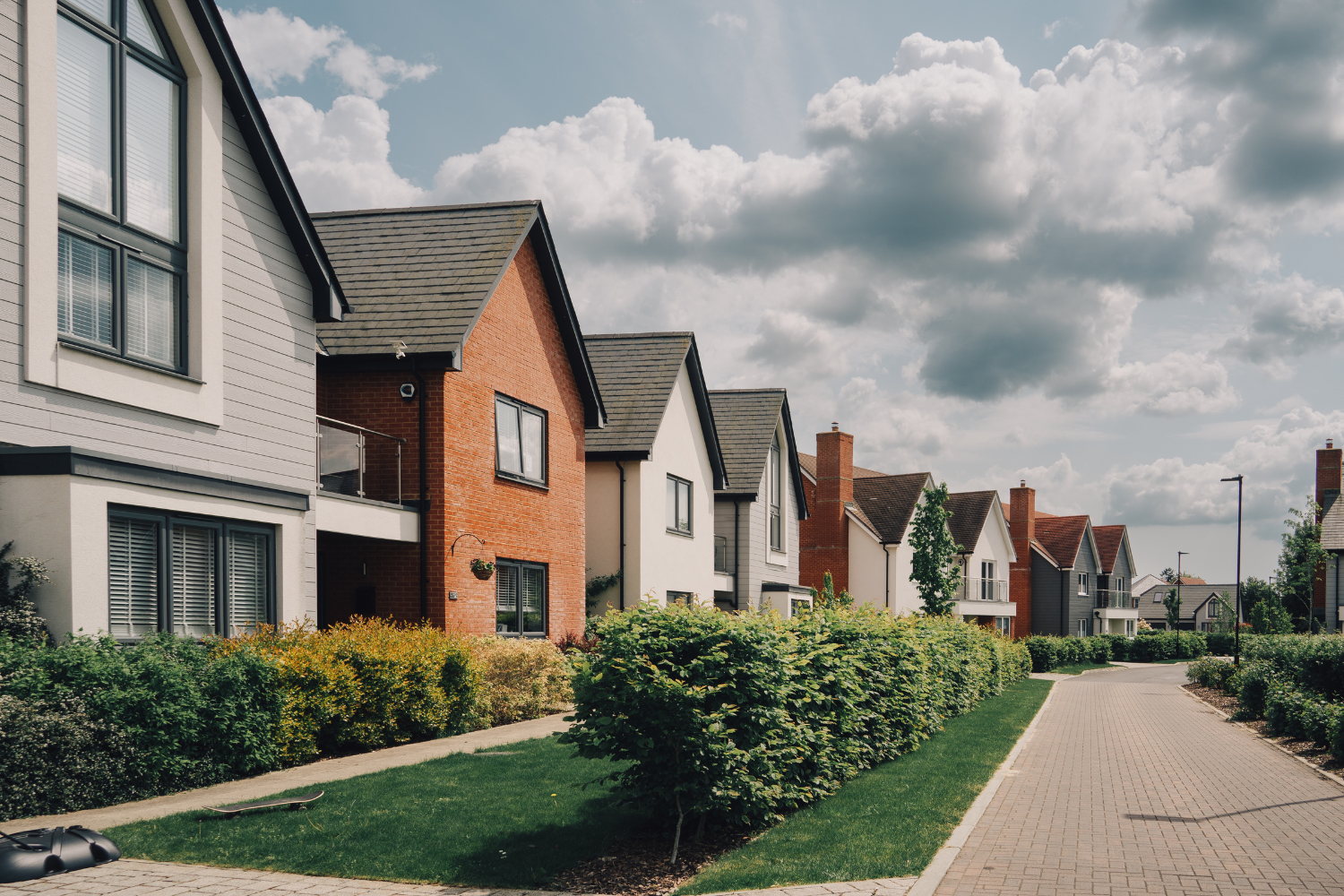 Street view including line of detached and semi-detached homes